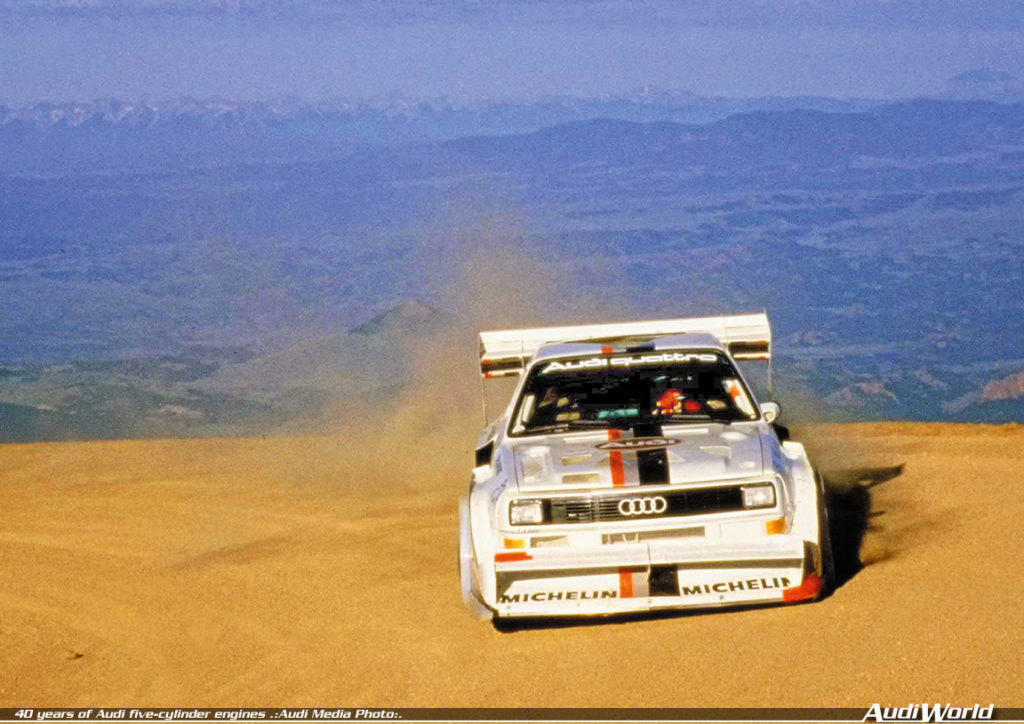 1987: world record at Pikes Peak with the Audi Sport quattro S1 (E2): In 1987, Walter Röhrl wins the legendary Pikes Peak Hill Climb (USA) in the Audi Sport quattro S1 (E2), setting a new record. In 10 minutes and 47.85 seconds he conquers the almost 20-kilometer-long (12.43 mi) course with 156 bends and a difference in altitude of 1,439 meters (4721.13 ft). The 2.1-liter five-cylinder engine in the Audi Sport quattro S1 (E2) delivers 440 kW (598 hp) at 8,000 revolutions per minute and produces 590 newton meters (435.16 lb-ft) of torque at 5,500 rpm.