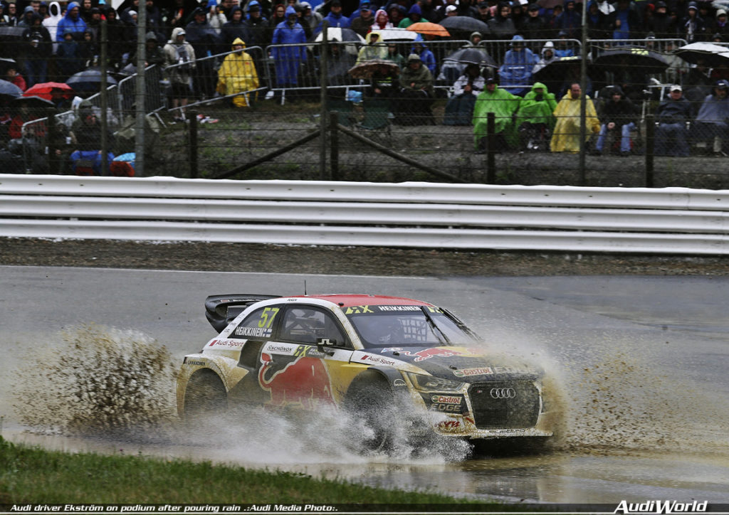 Audi driver Ekström on podium after pouring rain